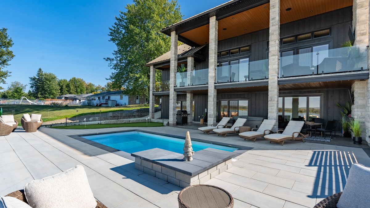 Wide view of backyard pool and outdoor living space