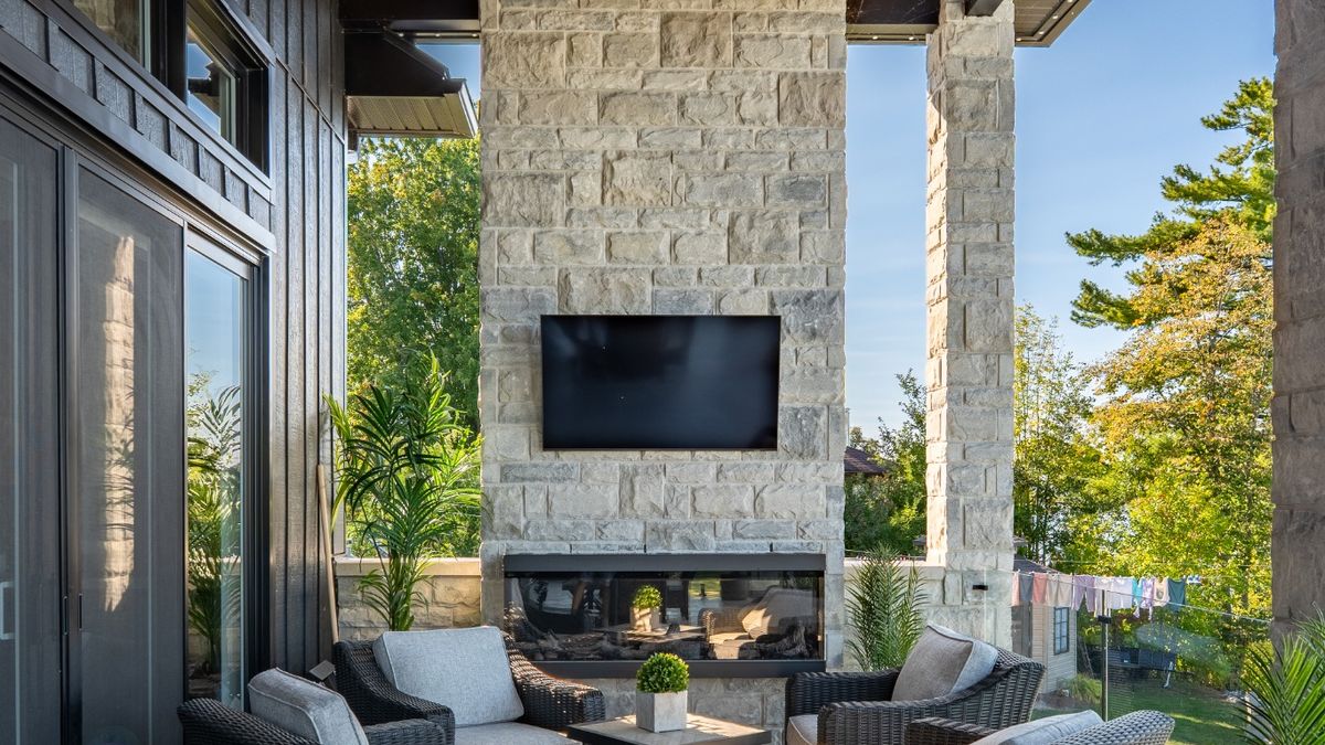 Covered outdoor seating area with fireplace