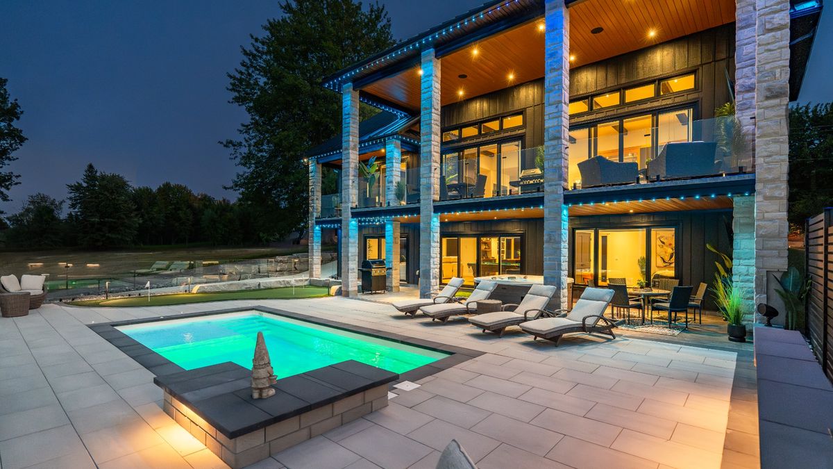 Night view of pool with outdoor lighting